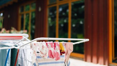 Wie kann man eine Pflegefamilie werden? Wäschestange mit Kinderkleidung drauf Wie kann man eine Pflegefamilie werden? Wäschestange mit Kinderkleidung drauf